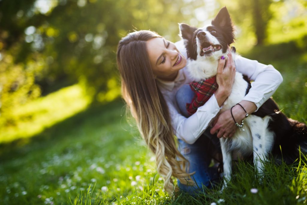 beautiful woman hugging dog